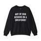 Black crewneck sweatshirt mockup with white text reading Any of Our Designs on a Sweatshirt.